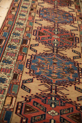 Low angle view of the dense wool pile and detailed geometric border on a vintage Serab rug.