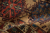 Rich texture of a vintage Serab runner's dense wool pile in sand, red, and sapphire blue.