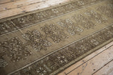 Distressed vintage Melas runner with quatrefoil medallions and geometric border in muted tones.