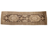 A vintage distressed Hamadan runner with two oversized medallions on an abrashed chocolate brown field.