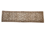 A vintage distressed Persian Dargezine runner with double floral medallions in chocolate brown and platinum.
