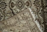 Folded corner of a distressed Persian runner showing the hand-knotted back, secure side cord, and fringe.