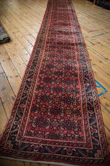 Vintage Hamadan runner's cherry red Herati field and dusty teal serrated leaf border.
