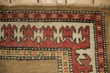 Antique Caucasian runner border with geometric reciprocating pawn motif in madder red, camel, and saffron.