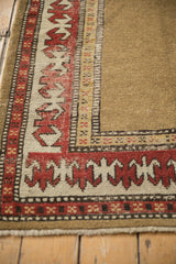 Close-up of antique Caucasian runner's unusual camel field, bordered by madder red pawn plant motif.