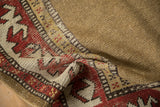 Textured camel field meets geometric border with reciprocating pawn plant motif on antique Caucasian rug.