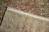 Distressed Karaja rug corner showing worn geometric pile and hand-knotted foundation.