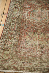 Distressed vintage Karaja runner displaying geometric patterns and muted tones of raspberry, green, and beige.