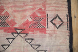 Distressed knot heads showing checkered relief and diamond motifs in mauve and charcoal.
