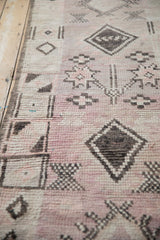 Low pile texture with mauve, charcoal, and unique polychromatic warps on a vintage Moroccan runner.
