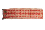 Vintage distressed Moroccan runner with shaggy pile and repeating red, peach, ivory diamond pattern.