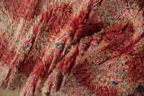 Thick shaggy pile of the distressed Moroccan runner, with cherry red, peach, and varied flecks.