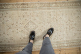 Distressed Hamadan runner, ivory beige Herati field, central diamond medallion, faded blue accents, feet.