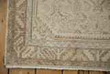 Vintage Hamadan rug corner with distressed pile, ivory fringe, and serrated leaf border.