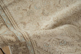 Worn texture of a vintage distressed Hamadan runner pile with faded ivory and pale blue patterns.