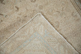 Distressed Hamadan rug runner corner showing worn pile, intact selvage, and hand-knotted back with faint blue.