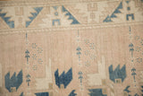 Even wear to the knot heads on a distressed Oushak rug in dusty mauve and blue.