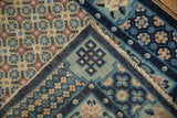 Vintage Peking rug runner showing exposed foundation, side selvage, and geometric blossoms.