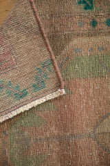 Textured pile and reverse weave of a distressed Persian rug, with visible foundation.