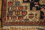 Low, even pile and exposed knot heads on the corner of an antique Persian Malayer rug.