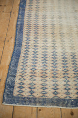 Distressed Oushak rug: textured dusty royal blue border and worn antique ivory field.