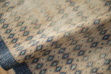 Distressed pile texture of vintage Oushak runner, showing blue, mint, and sandalwood diamond motifs.