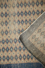 Distressed hand-knotted Oushak runner showing worn dusty blue diamond blossoms and woven reverse.