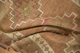 Heavy abrashes and geometric patterns on a distressed vintage Kurd runner in blush and sand tones.