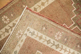 Evenly worn hand-knotted pile and visible foundation of a vintage Kurd runner.