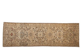 Vintage distressed Karaja runner with repeating geometric medallions in a sandy brown and neutral color palette.