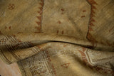Distressed vintage Serab runner pile with folds, revealing dusty saffron and chestnut geometric details.