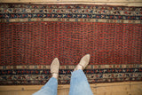 Kurdish Hamadan runner: Madder red boteh field with subtle animals, geometric blue borders.
