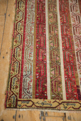Close view of the vintage Anatolian runner's repeating vine patterns and restored side cord selvage.