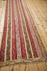 Vintage Anatolian runner seen along its full length, emphasizing the repeating geometric stripes.