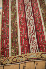 Vintage Anatolian runner corner with striped red and green patterns and a saffron border.