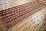 Vintage Anatolian runner with repeating parallel bands of red, olive green, and ivory.