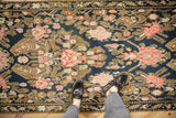 Intricate floral bouquets in copper and blush tones on the navy field of an antique Karabagh runner.