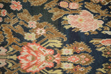 Intricate blush and copper floral bouquets on the low pile of an antique Karabagh runner.