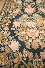 Low-pile texture and intricate floral blossoms on an antique Armenian Karabagh rug runner.