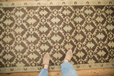 Distressed Oushak runner with coffee brown and cream Rococo lattice floral pattern.