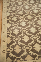 Cream side selvage and coffee brown stylized Rococo pattern on vintage Oushak runner.