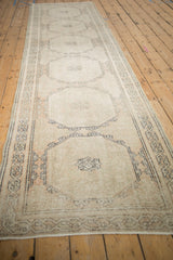 Distressed vintage Sparta runner, highlighting octagonal gul with pale peach and silver tones.