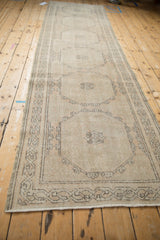 Close-up of distressed Sparta runner with worn octagonal guls and muted neutral tones.