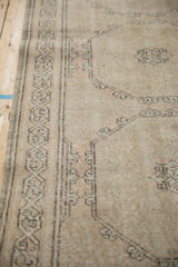 Distressed Turkish Sparta runner detail: meandering vine border, muted peach, sandalwood, and silver tones.