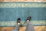 Distressed Mir Sarouk runner: faded sapphire blue field, repeating botehs, patterned ivory border.