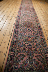 Detail of vintage Dargezine runner: dusty rose thousand flower motif, dark blue border, intact selvage.