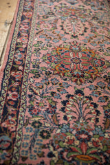 Vintage Persian Dargezine rug: dusty rose field, colorful floral blossoms, and ornate border detail.
