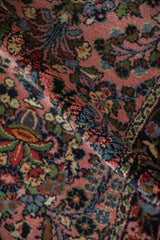 Rich pile of Dargezine runner showing dusty rose, sky blue, and green thousand flower motifs.