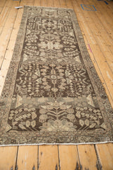 Repeating floral bouquets and meandering vines on distressed Dargezine rug, chocolate and platinum hues.