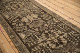 Persian Dargezine runner's distressed chocolate field, featuring muted platinum floral bouquets.